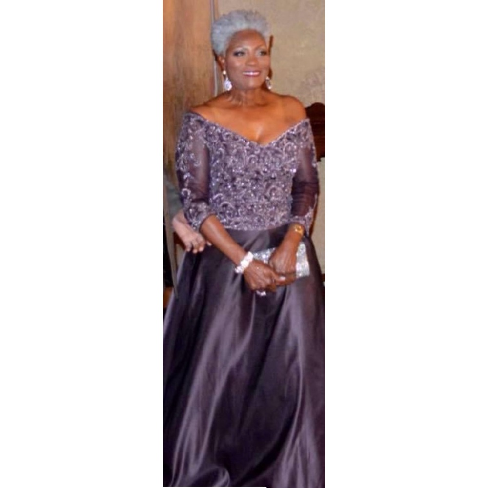 Fit-and-flare formal gown with glittering accents and three-quarter sleeves.